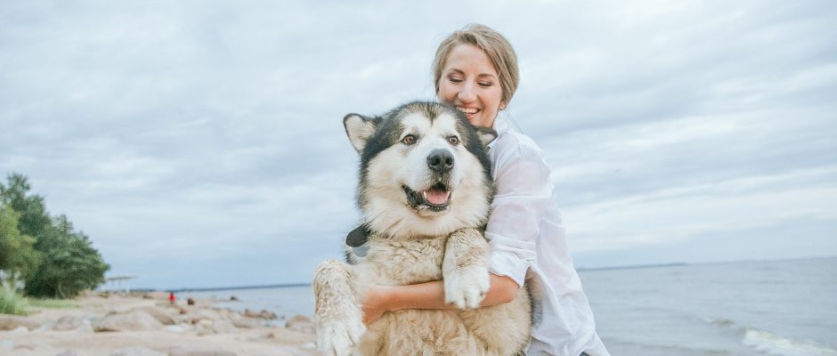Woman Hugging Siberian Husky Dog